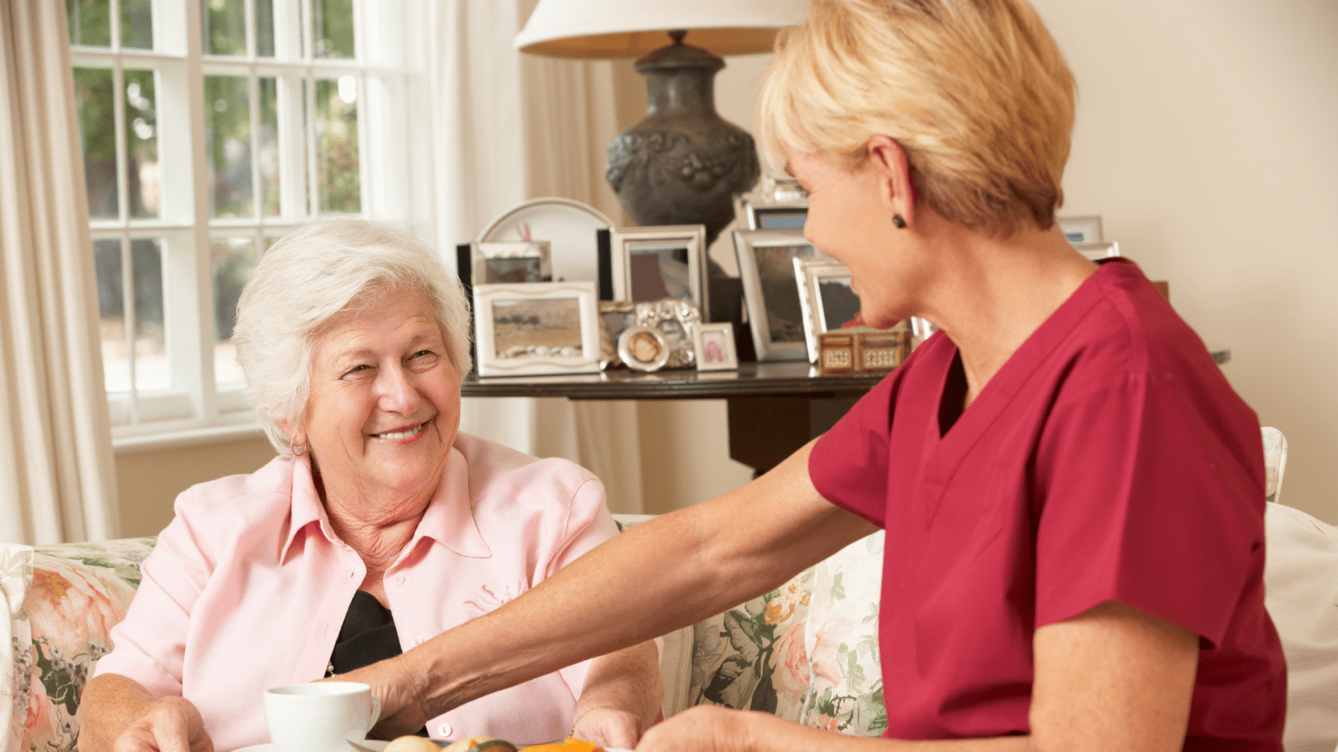 4 female employee at Grace Pointe smiling at an older woman