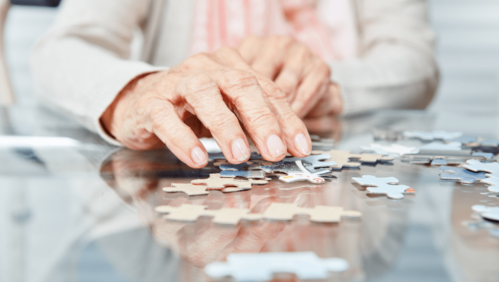 Memory Care Activities Senior doing a puzzle at a memory care facility