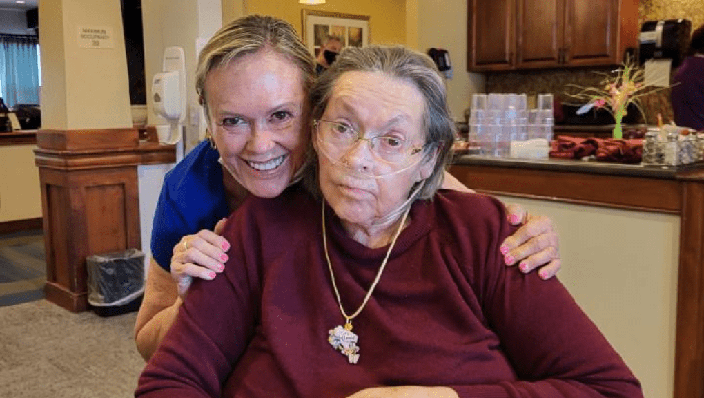 GP_Featured Image Template (4) Registered Nurse (RN) caring for and hugging resident at senior assisted living facility