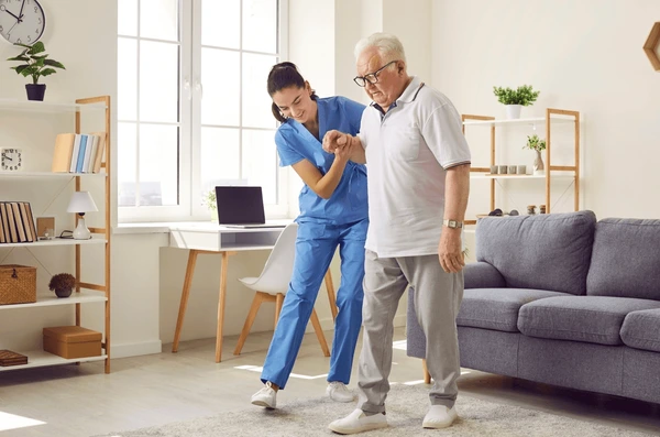 young-nurse-helping-elderly-man-600nw-2216879681